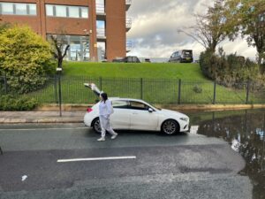 Fire service rescue woman trapped in car on flooded road