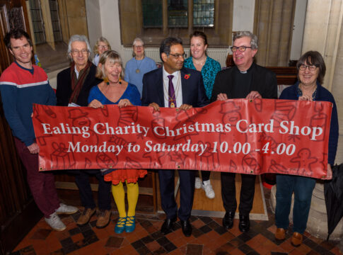 Volunteers at the opening of the Ealing Charity Christmas Shop with Sue Green, founder (fourth from left); Ealing’s Immediate Past Mayor, Councillor Munir Ahmed (centre); and Father Richard Collins, Vicar of Parish Church of Christ the Saviour (second from right) which is where Card Shop will be open 10am-4pm until 18 December 2022.