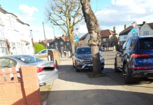 Car parked on pavement and sticking out into pavement