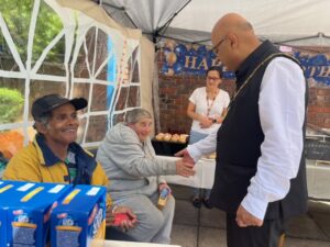 Mayor of Ealing, Councillor Hitesh Tailor with local people at pop up soup kitchen at Clayponds