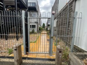 Entry to Marston Court in Hanwell. Entry system has been broken since 2020 and anyone can push gate and gain entry.