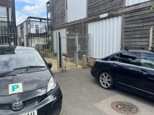 Cars block the entrance and exit of Marston Court in Hanwell