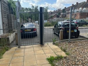 Cars block the entrance and exit to Marston Court in Hanwell