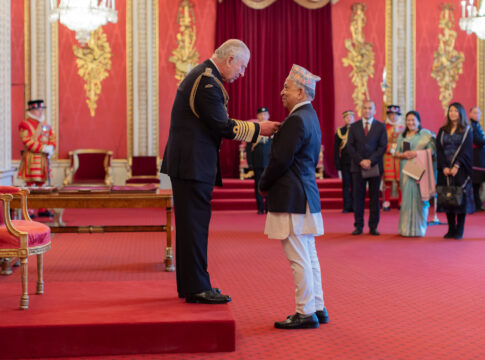 Mahanta Shrestha OBE and King Charles III at OBE investiture