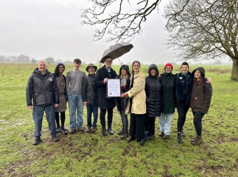Ealing Council leader Peter Mason (left) & cabinet member for thriving communities Blerina Hashani (right) present the Local Nature Reserve declaration to Katie Boyles, chair of the Brent River Park charity (centre) and members of the Warren Farm Nature Reserve campaign. Photo: Ealing Council