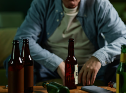 Man with multiple beer bottles. Photo: seventyfourimages / Envato
